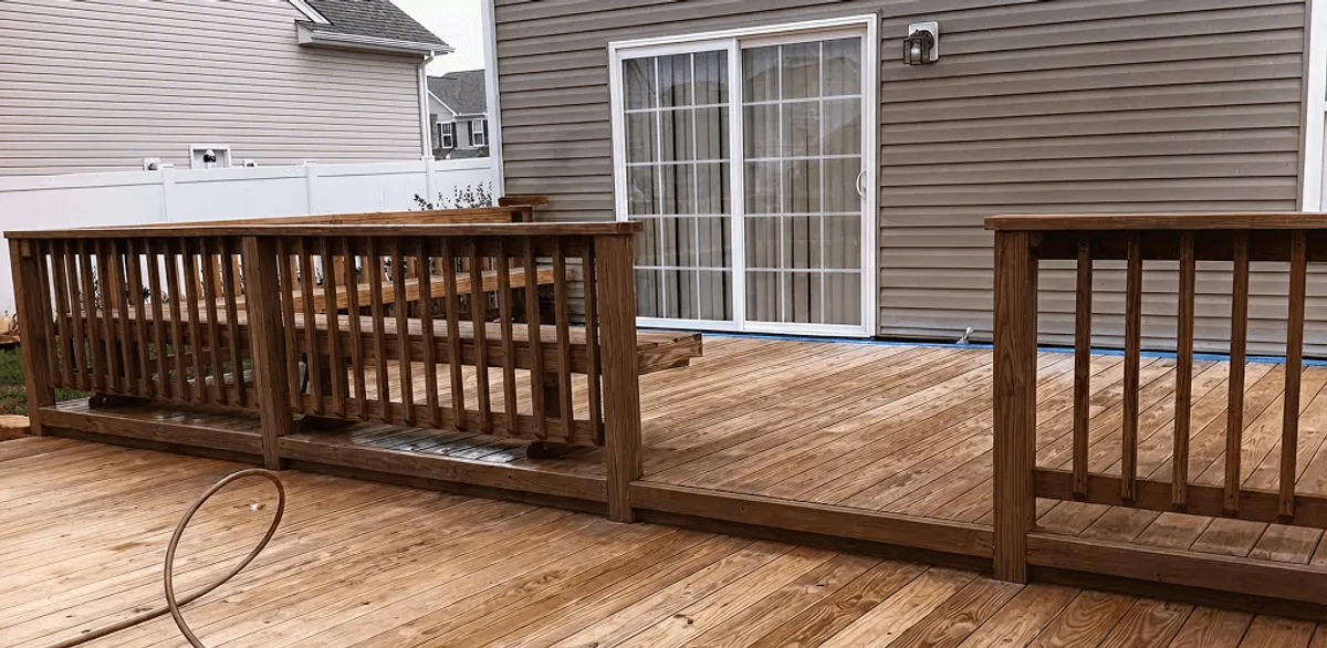 Deck sealing service protecting a backyard wood deck and railings in Memphis, TN