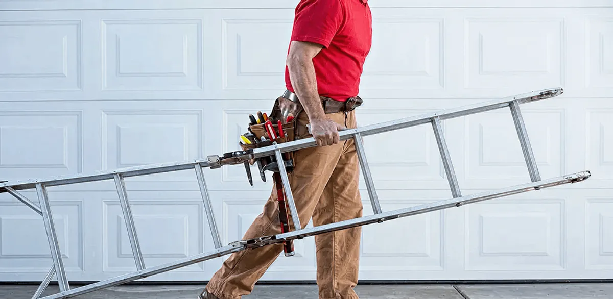 Garage door repair technician arriving with tools and ladder in Memphis, TN